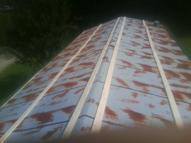 Rusted metal roof panels with new wood purlins before replacement — Storm Damage Roof Repair in Monsey by Roofing Brothers